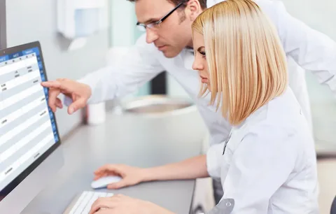 Medical billing specialists reviewing patient data on a computer for mental health billing services